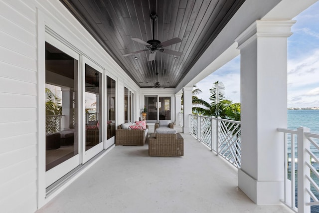 balcony with a water view and ceiling fan