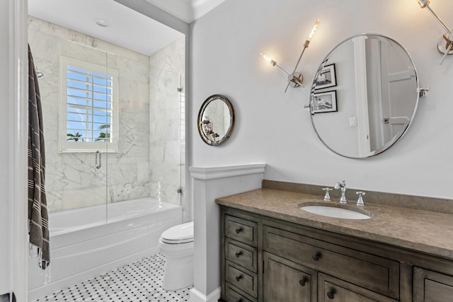 full bathroom featuring tiled shower / bath, vanity, and toilet