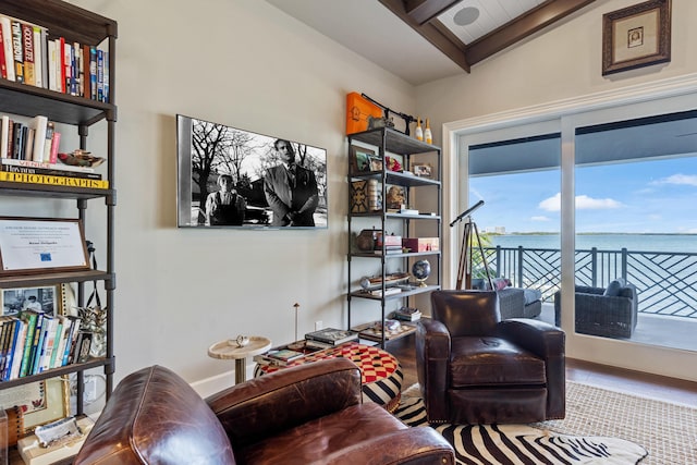 living area featuring lofted ceiling and hardwood / wood-style floors