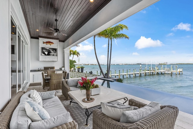 view of patio / terrace with a balcony, a water view, outdoor lounge area, and ceiling fan