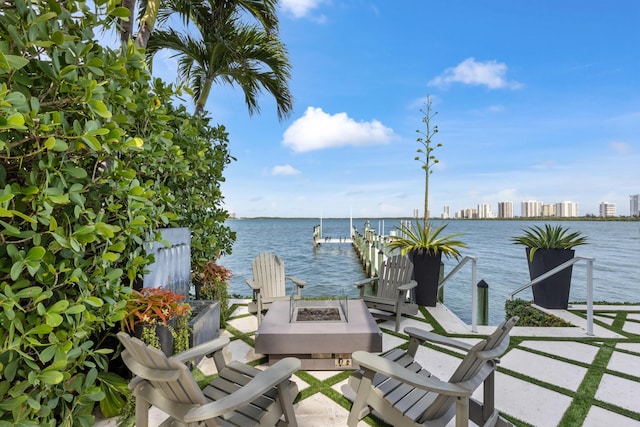 dock area with a water view and an outdoor fire pit