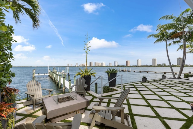 dock area with a water view and an outdoor fire pit