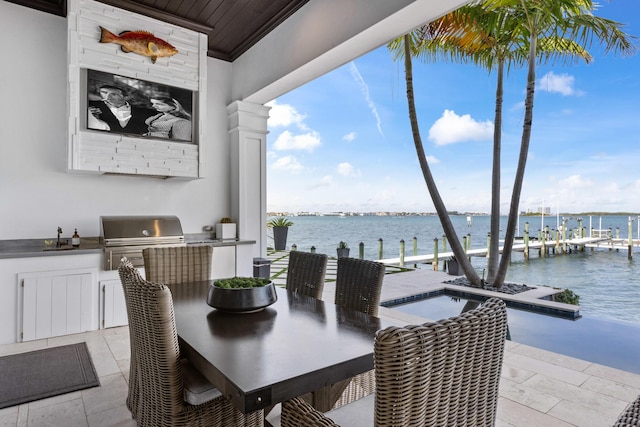 dining space with sink, wood ceiling, and a water view