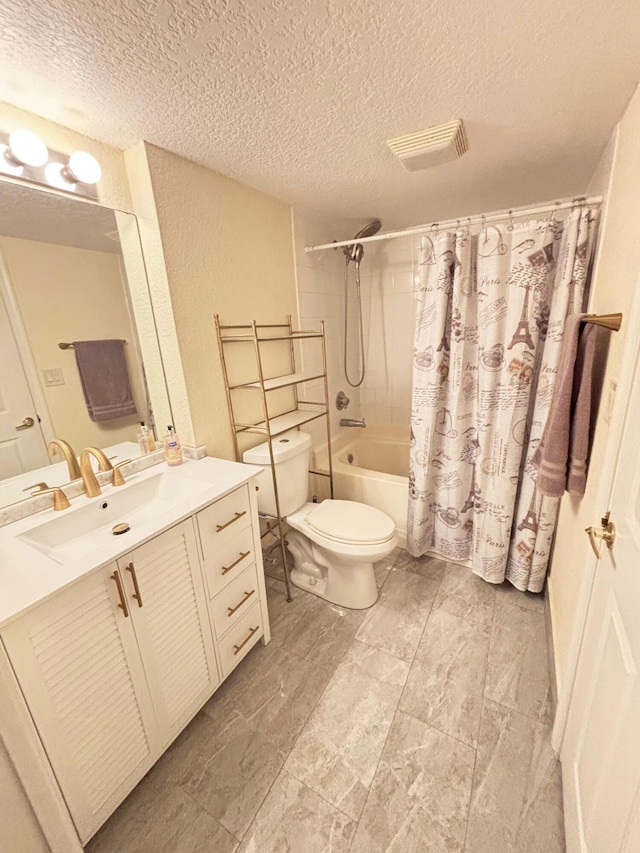 full bathroom featuring shower / bath combo with shower curtain, a textured ceiling, toilet, and vanity