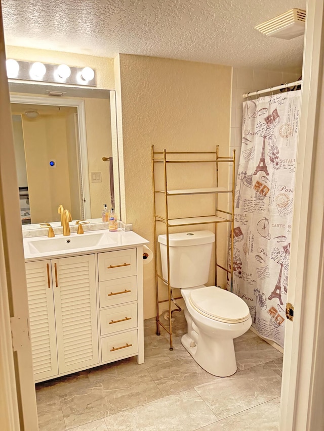 bathroom featuring a textured ceiling, toilet, vanity, and a shower with shower curtain