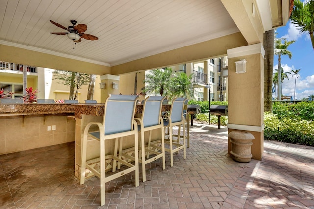 view of patio / terrace featuring exterior bar and ceiling fan