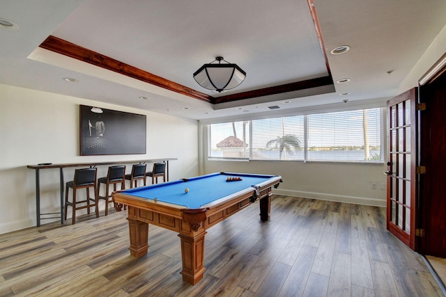 recreation room featuring hardwood / wood-style floors, pool table, and a raised ceiling