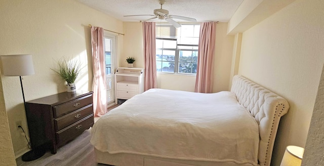 bedroom featuring ceiling fan and a textured ceiling