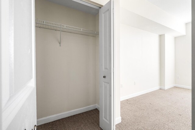 washroom featuring stacked washing maching and dryer, light tile patterned floors, and sink