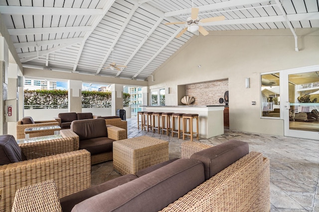 sunroom / solarium with ceiling fan, lofted ceiling with beams, and wood ceiling