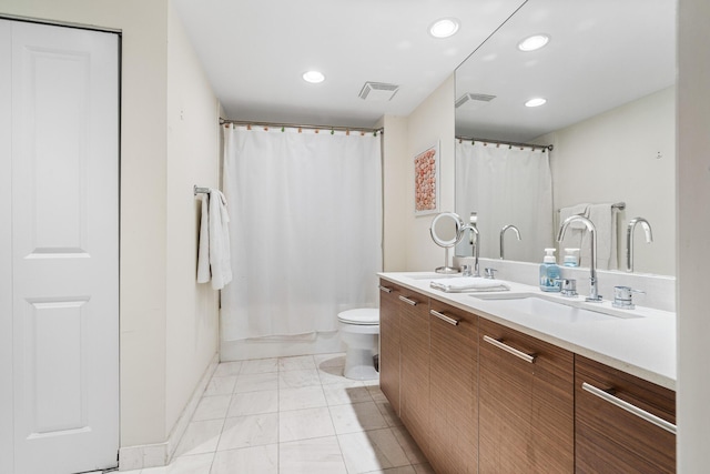 bathroom with toilet, walk in shower, and vanity