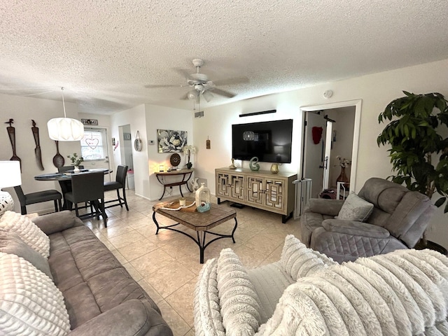 tiled living room featuring a textured ceiling and ceiling fan