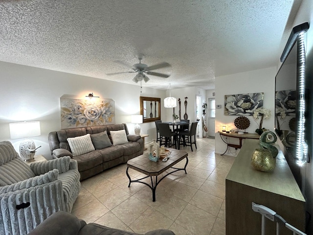 tiled living room with ceiling fan and a textured ceiling