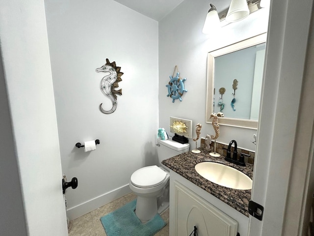 bathroom featuring toilet, tile patterned flooring, and vanity