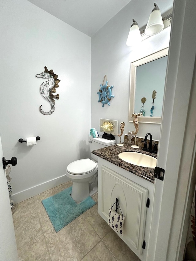 bathroom featuring toilet and vanity