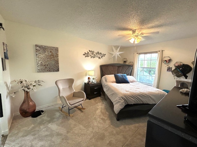 carpeted bedroom with ceiling fan and a textured ceiling