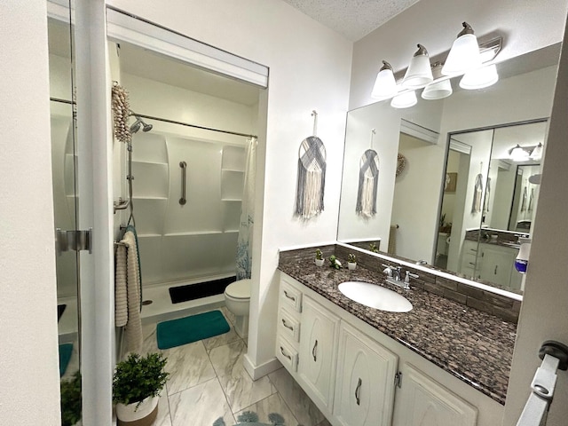 bathroom with a textured ceiling, toilet, and vanity