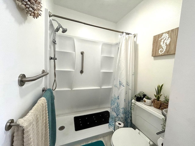 bathroom featuring toilet, tile patterned flooring, and walk in shower