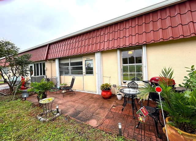 rear view of property featuring a patio