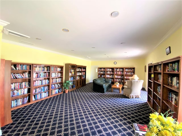 sitting room featuring crown molding and carpet flooring