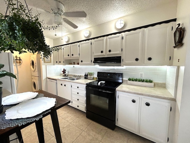 kitchen featuring tasteful backsplash, black electric range, white dishwasher, white cabinetry, and stacked washing maching and dryer