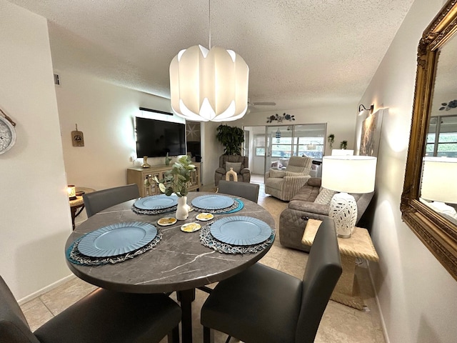 dining space with a chandelier and a textured ceiling