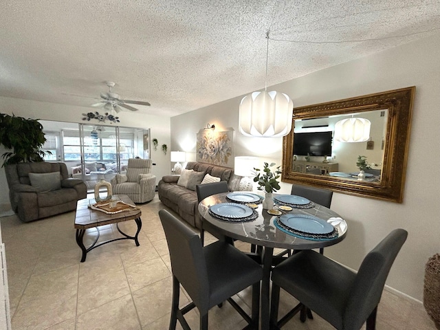 dining area featuring a textured ceiling and ceiling fan