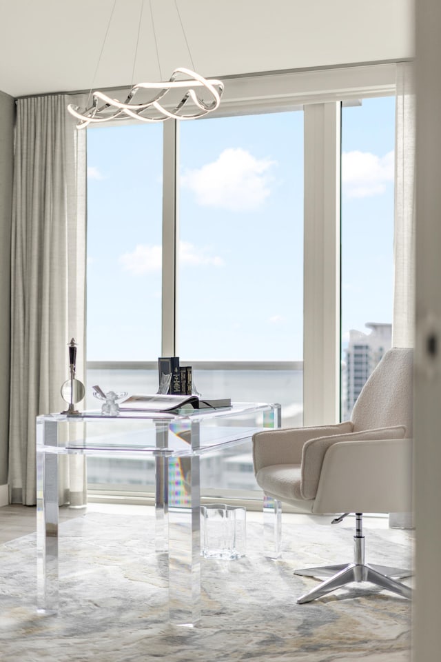 dining area featuring a water view and an inviting chandelier