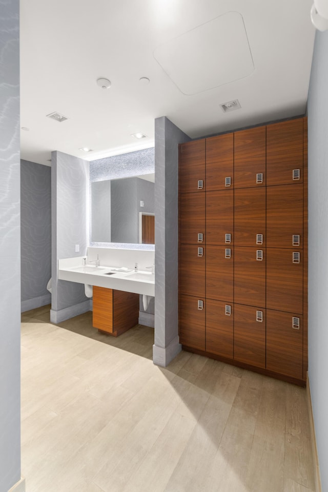 bathroom with vanity and hardwood / wood-style floors