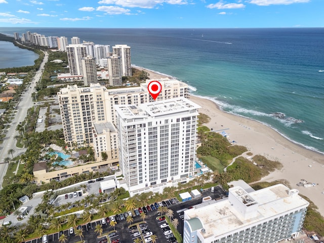 drone / aerial view featuring a beach view and a water view