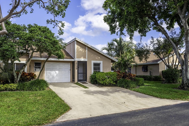 8089 Springtree Rd, Boca Raton, FL 33496 - view of front facade with a garage and a front yard