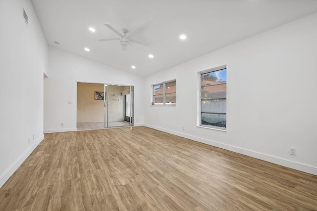 unfurnished room with lofted ceiling, ceiling fan, and light hardwood / wood-style flooring