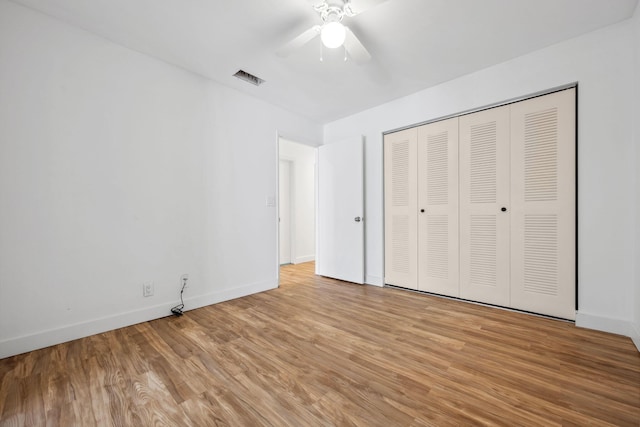 unfurnished bedroom with a closet, ceiling fan, and light hardwood / wood-style flooring