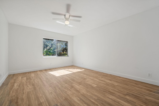 spare room with hardwood / wood-style flooring and ceiling fan