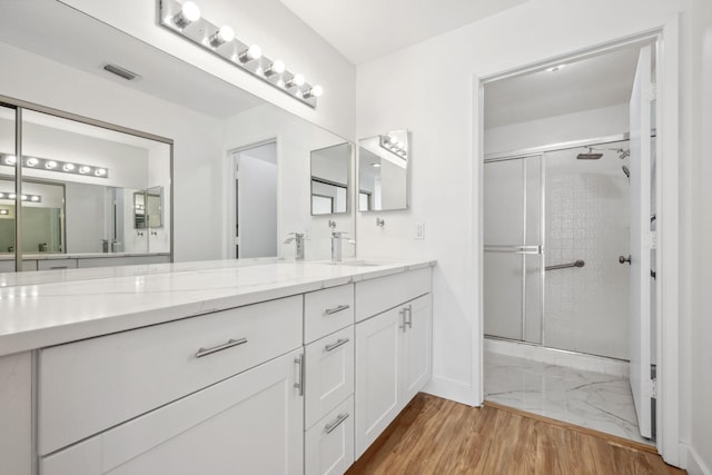 bathroom featuring vanity and a shower with shower door