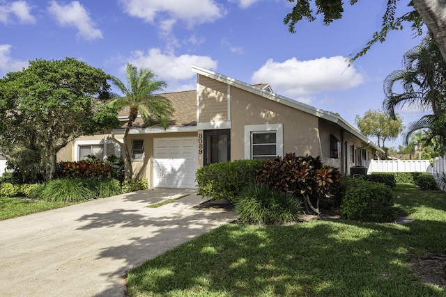 view of front of home with a garage and a front yard