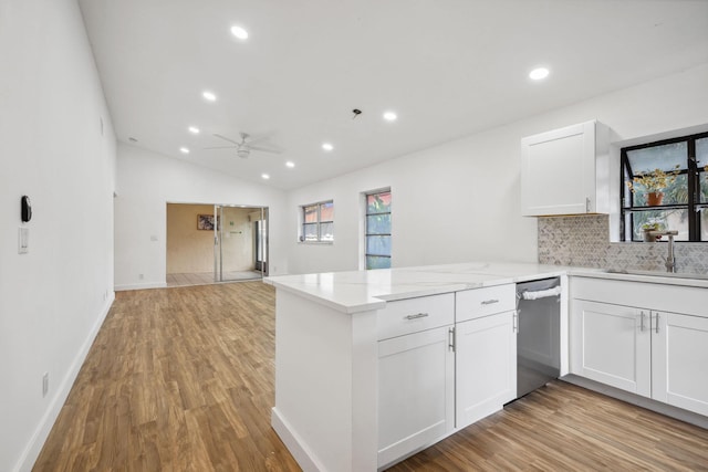 kitchen featuring kitchen peninsula, sink, and white cabinets