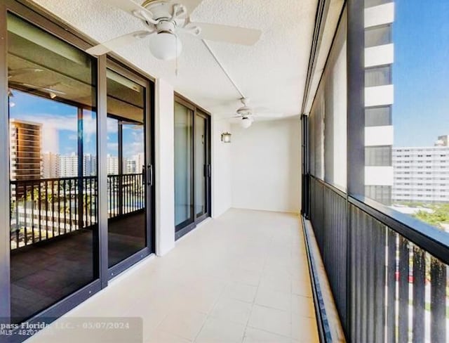 balcony with a city view and ceiling fan