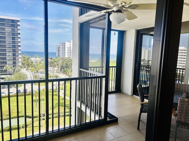 balcony featuring a city view and ceiling fan