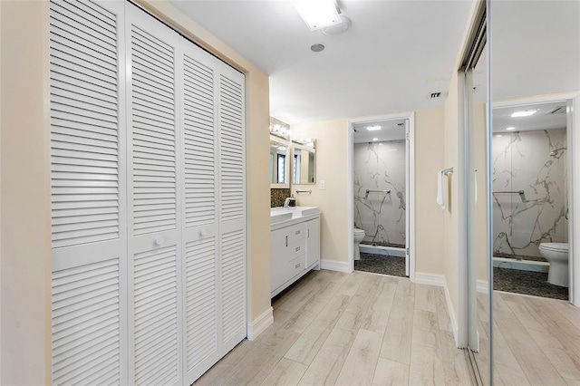 3420 S Ocean Blvd Unit 8Q, Highland Beach, FL 33487 - bathroom with a closet, a marble finish shower, wood finished floors, and vanity