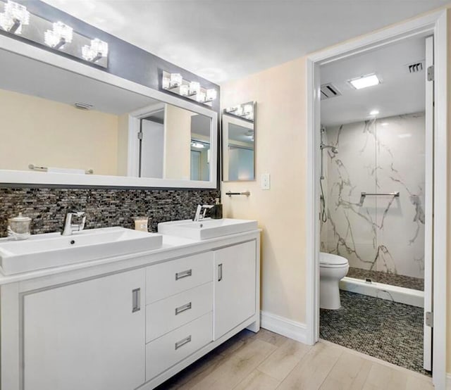 3420 S Ocean Blvd Unit 8Q, Highland Beach, FL 33487 - full bath with a marble finish shower, backsplash, double vanity, and wood finished floors