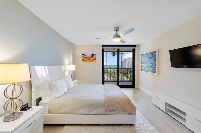 bedroom featuring ceiling fan, a wall of windows, access to exterior, and light wood-type flooring