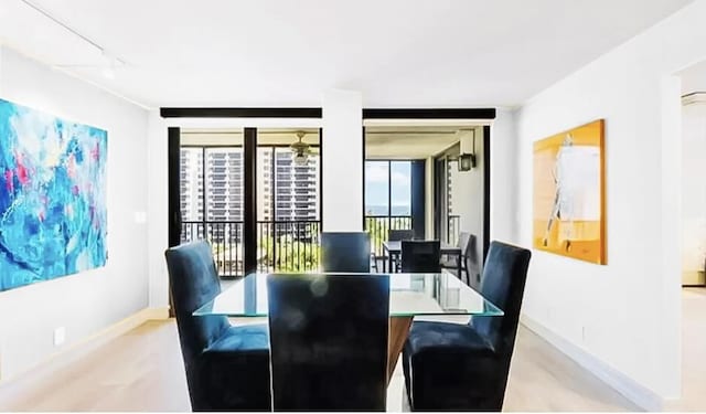 3420 S Ocean Blvd Unit 8Q, Highland Beach, FL 33487 - dining area with baseboards and rail lighting