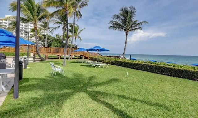 surrounding community featuring a lawn, a water view, and playground community