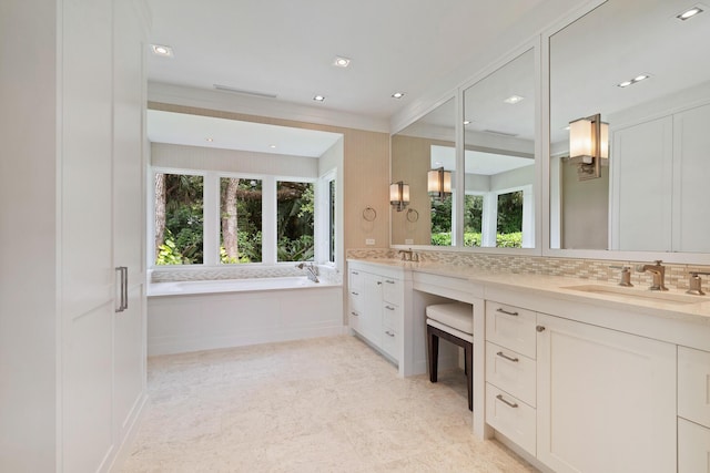 bathroom featuring decorative backsplash, a washtub, and vanity