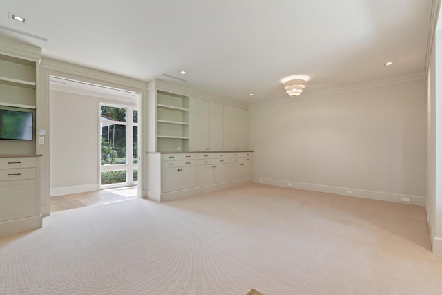 unfurnished living room with light colored carpet and ornamental molding