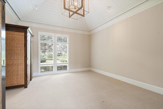 carpeted spare room with lofted ceiling, wooden ceiling, crown molding, and a barn door