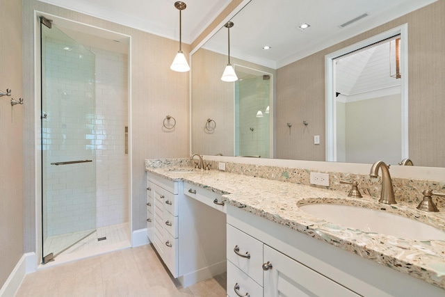 bathroom featuring vanity, crown molding, and walk in shower