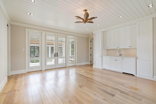 unfurnished living room featuring wood ceiling, light hardwood / wood-style floors, ceiling fan, french doors, and ornamental molding