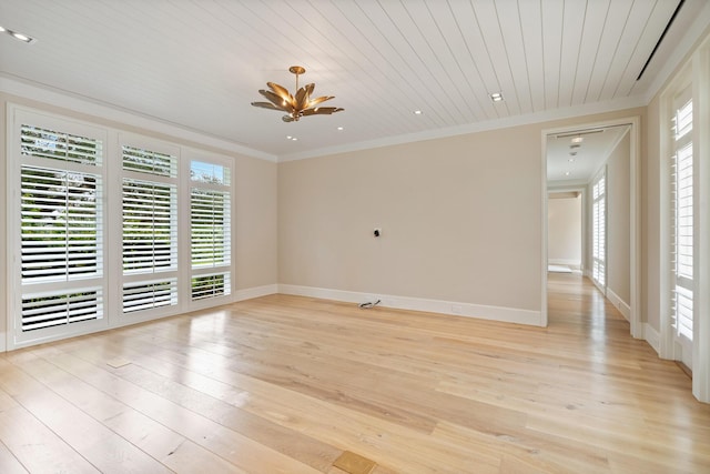 spare room featuring wood ceiling, ornamental molding, and light hardwood / wood-style floors